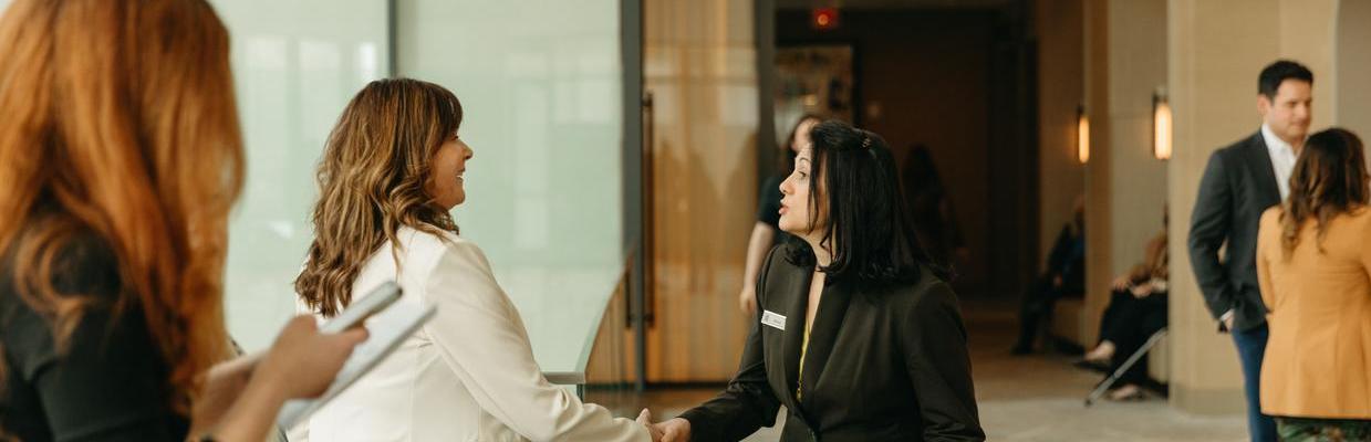 Two women shaking hands